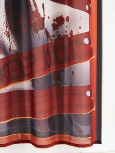 Close-up of Halloween door curtain with red blood splatters and black KEEP OUT warning text