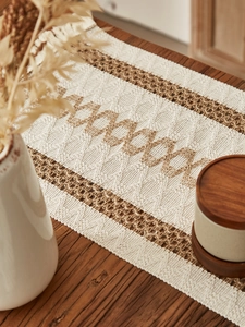 Detailed view of woven diamond pattern and fringe on cotton linen placemat with stripes