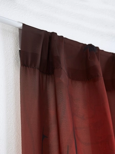 Detail of dark brownish red sheer Halloween door curtain with rod pocket hanging style