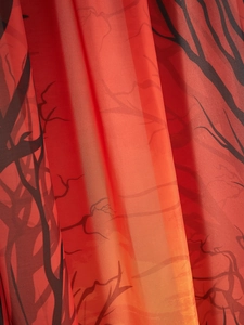 Macro detail of red and black gothic branch print fabric for Halloween curtains
