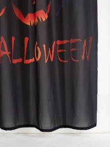 Detail of sheer black Halloween curtain with orange pumpkin faces and red blood text