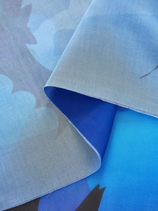 Detail of blue abstract print polyester fabric with visible weave for Halloween decor