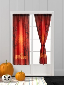 Detail view of Halloween curtains with orange sunset, dead trees, and bats silhouette