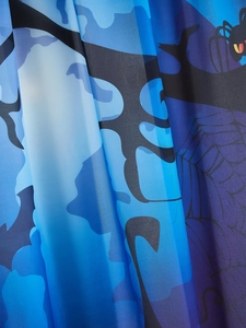 Detail of Halloween fabric with purple gradient, spider webs and spooky tree patterns