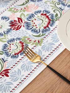 Detail of floral table runner with vintage print and high-density stitched edging