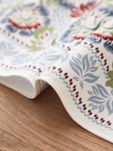 Detail shot of vintage floral pattern and textured fabric on Chinese style table runner