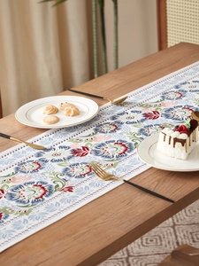 Detailed view of Chinese retro floral table runner with blue and burgundy botanical prints