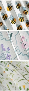 Detailed view of three floral patterns on folding door curtains with textured fabric