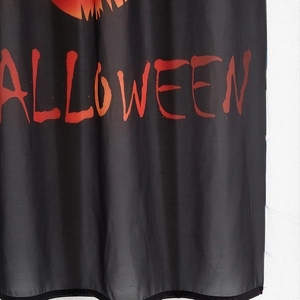 Halloween decorative curtain featuring black fabric with orange gradient lettering and pumpkin
