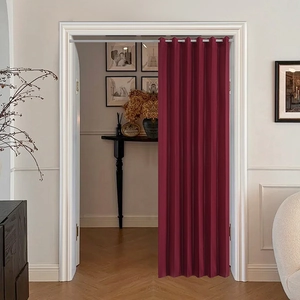 Detail of burgundy blackout curtain with fine texture and vertical folds for doorways