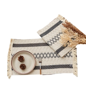 Bohemian woven table runner with grey geometric patterns and elegant cotton tassels