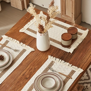 Minimalist woven cotton table runner with brown stripes and tassels on wooden table