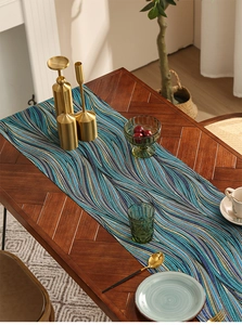 Blue wave pattern table runner detail on wooden dining table with elegant decor