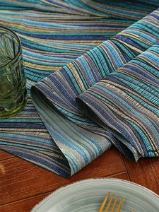 Detailed woven texture of luxury striped table runner with gradient blue and beige patterns