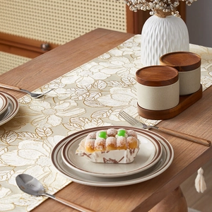 Luxurious cream floral table runner with gold embroidery and fringe for home decor