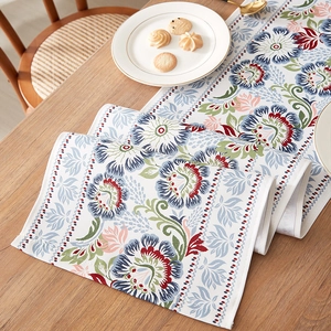 Classic Chinese floral table runner with vintage flower print on natural wood dining table