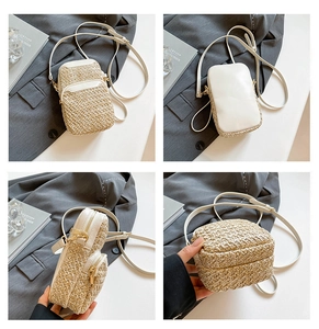 Detail view of woven straw crossbody bag with white leather trim and dual zippers