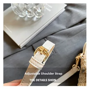 Detail of adjustable white leather shoulder strap with gold metal buckle and stitching