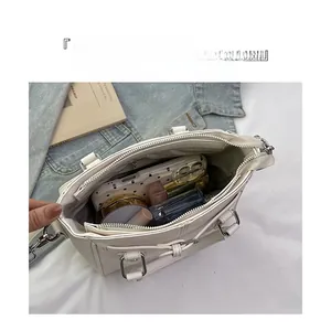 Top view of the spacious white pebble leather tote interior with zipper compartments