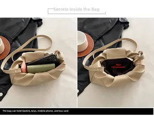 Detail showing the inner capacity of the beige pleated cloud bag for daily essentials
