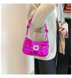 Close-up of metallic purple pleated shoulder bag featuring a crystal-encrusted square buckle