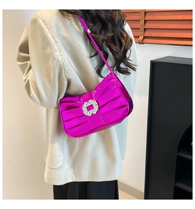 Detailed back view of a metallic purple pleated shoulder bag with sparkling rhinestone buckle