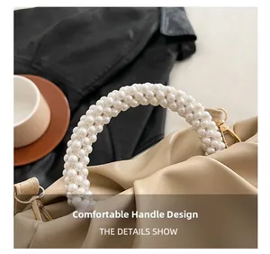 Detail of a pleated cream cloud bag featuring a handcrafted white pearl beaded handle