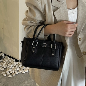 Classic black pebbled leather moto tote bag with silver rivets and metal buckle detailing