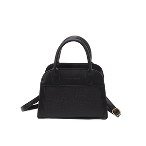 Chic black shell-shaped handbag with dual handles and gold-toned fashion hardware