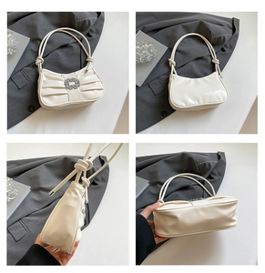 Detailed views of a white pleated underarm bag with a sparkling rhinestone buckle