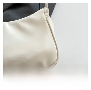 Macro shot of off-white pleated leather detail showing fine stitching and matte texture