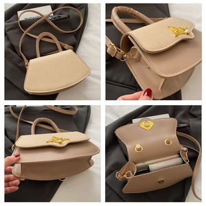 Detailansicht der beigen fächerförmigen Handtasche mit Webmuster und Schmetterlingsverschluss