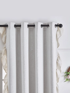 Detailed texture of thick linen curtains with cream ruffles and silver metal grommets