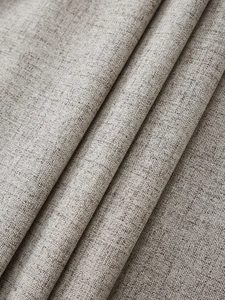 Macro shot of thick light grey faux linen fabric with natural textured weave pattern