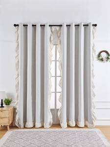Detail of light gray blackout linen curtain featuring elegant ruffled edges and grommet top