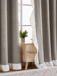 Close-up of grey linen blackout curtain with elegant white ruffled edge for living room