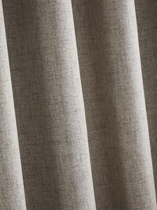 Close-up of thick grey linen curtain fabric showing detailed weave and soft draping