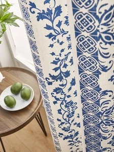 Detail of blue floral porcelain pattern on linen blend fabric with quality stitching