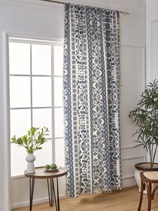 Detailed view of blue and white floral porcelain style curtain with boho fringe trim