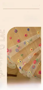 Close-up of colorful floral embroidery on thickened lace tablecloth in vintage style