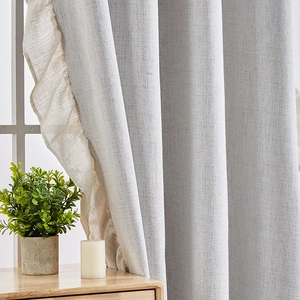 Thick light gray linen curtains with cream ruffled edges for a modern living room