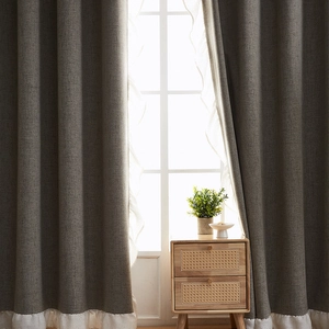 Thick charcoal grey linen blackout curtains with elegant cream ruffled edges for living room