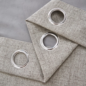 Close-up of thick linen blackout curtain with silver metal grommet rings