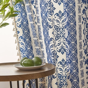 Blue and white porcelain style curtains with damascus pattern and beige tassel trim