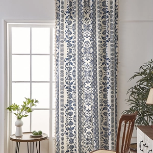 Blue porcelain pattern curtains with beige tassels in a vintage bohemian interior setting