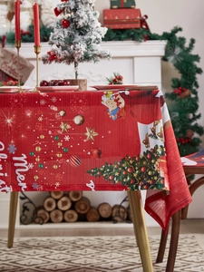 Detailed texture of red Christmas tablecloth with Merry Christmas text and festive patterns