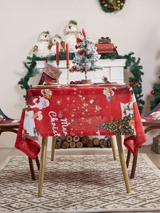 Detailed close-up of Merry Christmas patterns and Santa Claus print on festive red tablecloth