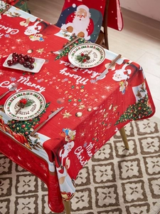 Close-up of red Christmas tablecloth featuring Santa Claus and woven fabric texture