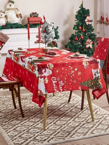 Detail of red Christmas tablecloth with Santa Claus and Merry Christmas print