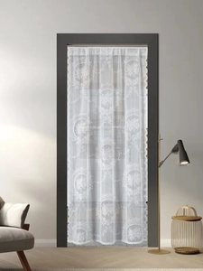 Close-up of white French lace door curtain with floral embroidery and scalloped edges